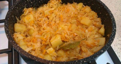 Тушеная с капустой на каменной сковороде картошка с луком