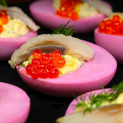 Закуска из розовых фаршированных яиц