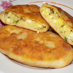 Жареные пирожки на сковороде с рисом и яйцом