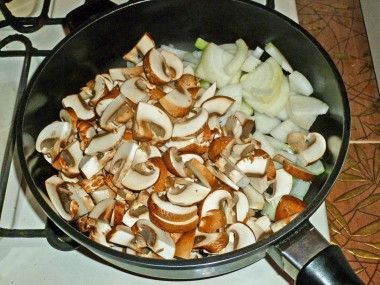Рецепт - Салат Восторг с жареными грибами без орехов и чернослива - Шаг 5 -  Разогрейте на плите сковороду. Налейте в нее растительное масло. Положите лук и грибы.