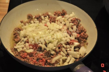 Рецепт - Фарш с сыром луком и помидорами в лаваше - Шаг 3 -  Фарш размораживаем и перекладываем в глубокую миску. Конечно, лучше использовать свежий фарш, который не был предварительно заморожен. А еще лучше - приготовленный собственноручно. Для этого блюда можно взять смешанный свиноговяжий фарш. Всыпаем к фаршу измельченный лук, солим, перчим и обжариваем на растительном масле.