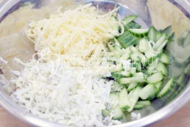 Рецепт - Салат Новогодняя горка - Шаг 3 -  В миске смешать тертые отварные яйца, тертый сыр и соломкой нарезанный огурец