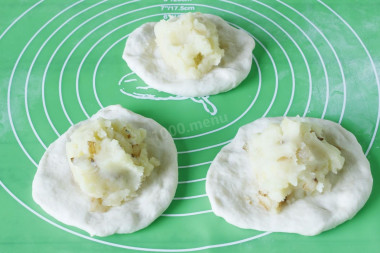 Рецепт - Жареные пирожки на сковороде на молоке - Шаг 6 -  Берем кусочек теста, слегка приминаем его руками и формируем небольшую лепешку, выкладываем на середину начинку - по столовой ложке с горкой. Так подготавливаем все кусочки.